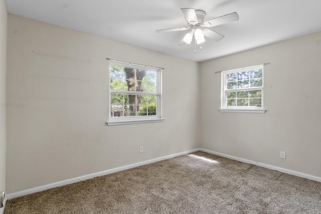 spare room featuring carpet flooring, a ceiling fan, and baseboards