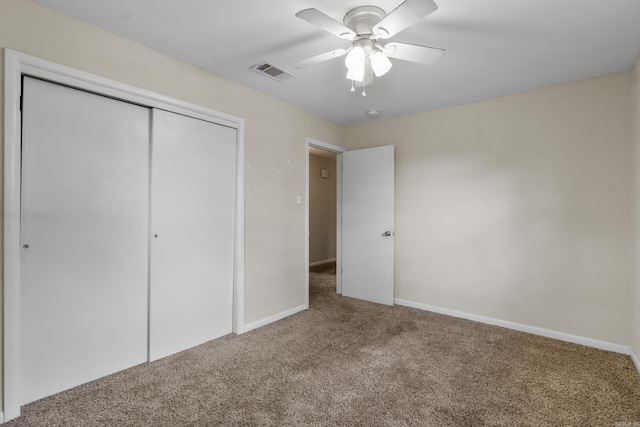 unfurnished bedroom with visible vents, carpet floors, a closet, baseboards, and ceiling fan