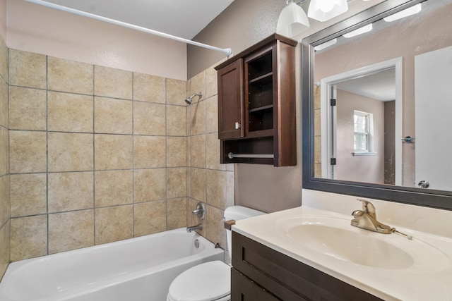bathroom with vanity, toilet, and  shower combination