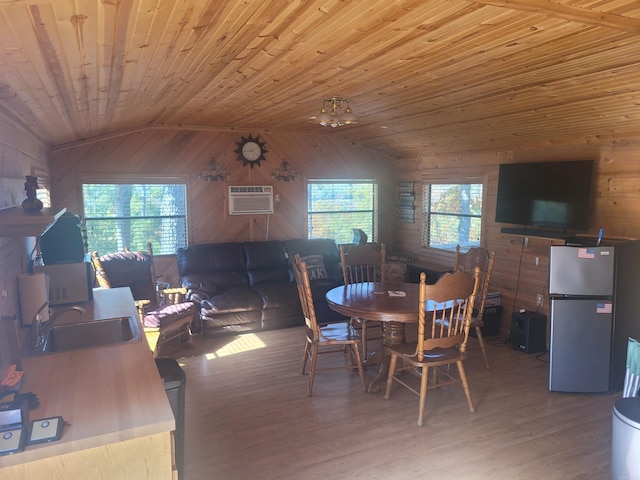 290 Christopher Dr, Quitman, AR 72131 - dining room featuring wood walls, wood finished floors, lofted ceiling, a wall unit AC, and wooden ceiling