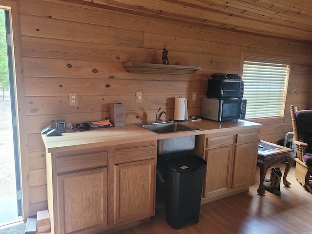 290 Christopher Dr, Quitman, AR 72131 - kitchen featuring a sink, wood walls, wood finished floors, and a wealth of natural light