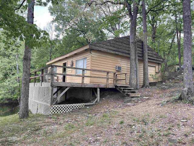 rear view of house with a wooden deck