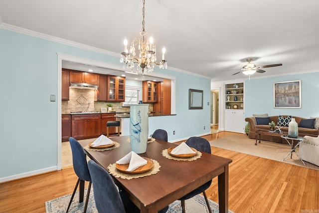 416 Ivory Dr, Little Rock, AR 72205 - dining area with built in features, light wood-type flooring, baseboards, ceiling fan with notable chandelier, and ornamental molding