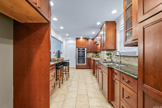 416 Ivory Dr, Little Rock, AR 72205 - kitchen featuring a sink, double oven, dark stone counters, recessed lighting, and tasteful backsplash