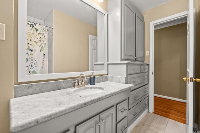 416 Ivory Dr, Little Rock, AR 72205 - bathroom featuring a shower with shower curtain, wood finished floors, and vanity