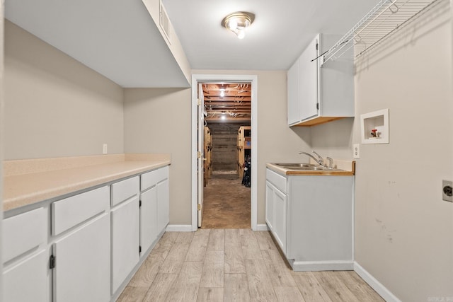 416 Ivory Dr, Little Rock, AR 72205 - laundry area featuring electric dryer hookup, a sink, washer hookup, and light wood-style floors
