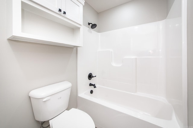 bathroom featuring shower / bathtub combination and toilet