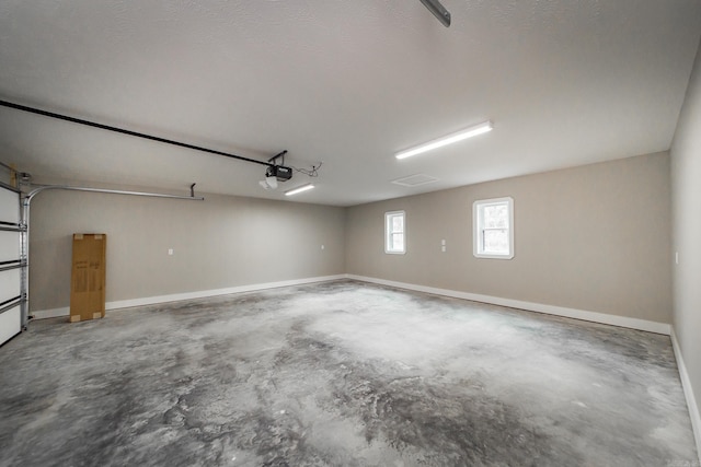 garage with baseboards and a garage door opener