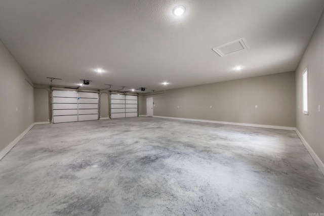 garage with baseboards and a garage door opener