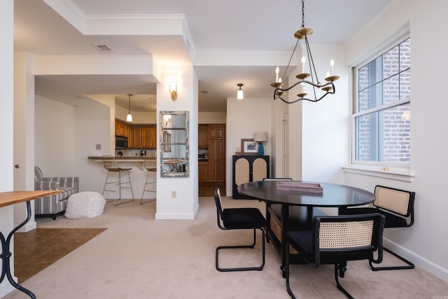 523 S Louisiana St Unit 10A, Little Rock, AR 72201 - dining room with crown molding, light colored carpet, baseboards, and a notable chandelier