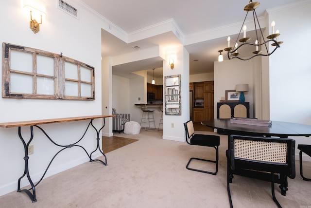 523 S Louisiana St Unit 10A, Little Rock, AR 72201 - carpeted dining room featuring crown molding, baseboards, visible vents, and an inviting chandelier