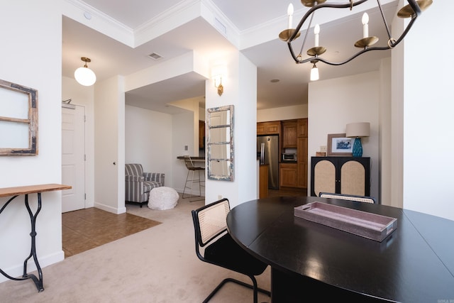523 S Louisiana St Unit 10A, Little Rock, AR 72201 - dining area with crown molding, baseboards, visible vents, and carpet