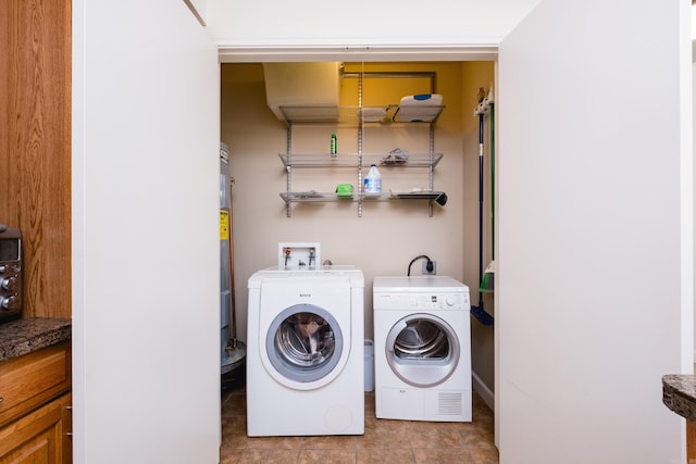 523 S Louisiana St Unit 10A, Little Rock, AR 72201 - laundry room with tile patterned flooring, laundry area, and washing machine and dryer