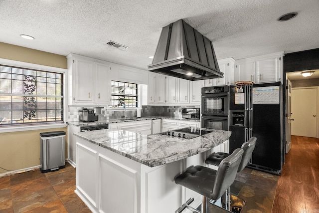 7510 Briarwood Dr, Little Rock, AR 72205 - kitchen with white cabinets, a textured ceiling, extractor fan, and black appliances