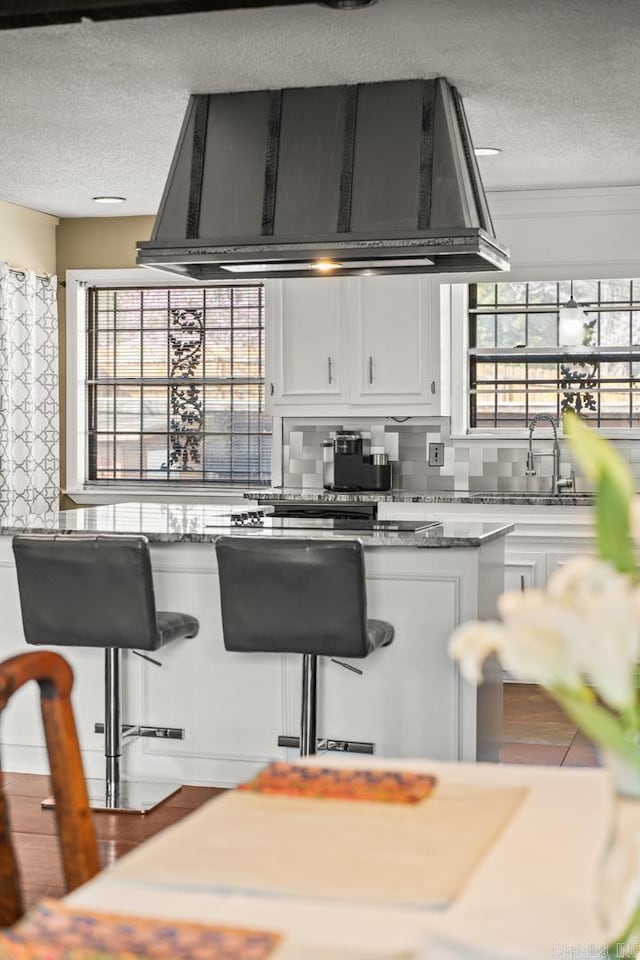 7510 Briarwood Dr, Little Rock, AR 72205 - kitchen featuring custom range hood, a textured ceiling, and white cabinetry