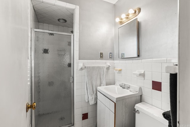 7510 Briarwood Dr, Little Rock, AR 72205 - full bath featuring tile walls, a shower stall, a wainscoted wall, and vanity