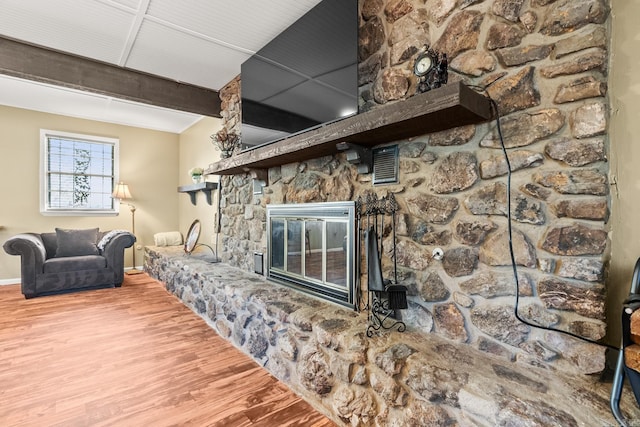 7510 Briarwood Dr, Little Rock, AR 72205 - living room featuring baseboards, a stone fireplace, wood finished floors, and visible vents