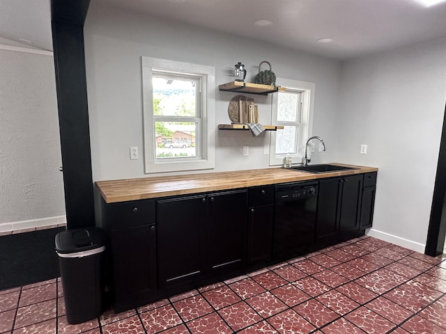 kitchen featuring open shelves, a sink, dishwasher, dark cabinets, and wood counters