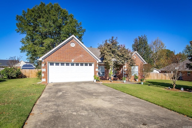 view of front facade with driveway, brick siding, fence, a front lawn, and an attached garage