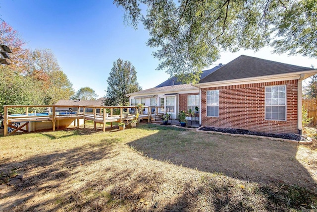 20 N Gettysburg, Cabot, AR 72023 - back of house featuring a yard, brick siding, a wooden deck, and roof with shingles