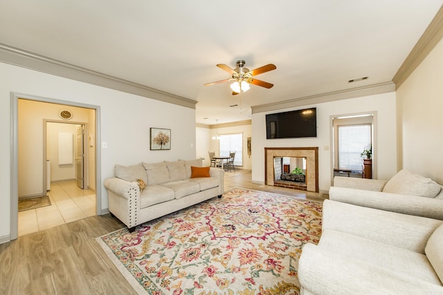20 N Gettysburg, Cabot, AR 72023 - living area with visible vents, ornamental molding, light wood-style floors, baseboards, and ceiling fan