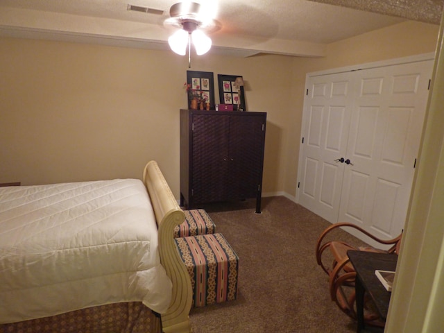 bedroom featuring carpet floors, ceiling fan, visible vents, and a closet