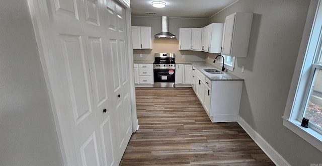 1620 S Harrison St, Little Rock, AR 72204 - kitchen featuring stainless steel range, a sink, wall chimney range hood, and dark wood finished floors