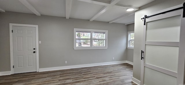 1620 S Harrison St, Little Rock, AR 72204 - unfurnished room featuring beamed ceiling, wood finished floors, a barn door, and baseboards