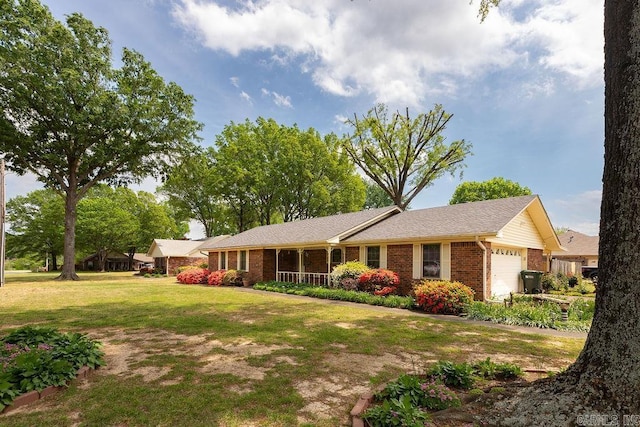 ranch-style house with an attached garage, a front yard, and brick siding