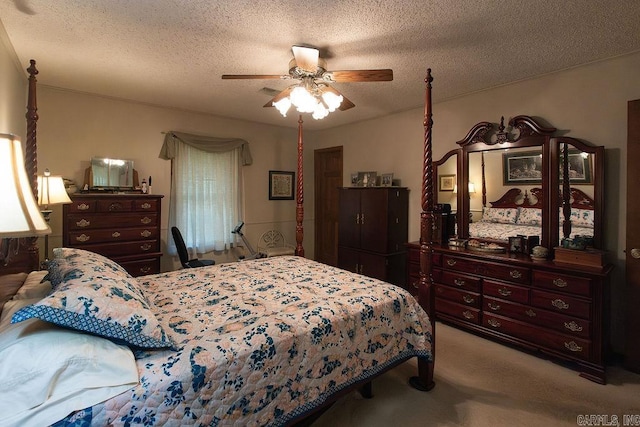 carpeted bedroom featuring a textured ceiling and ceiling fan