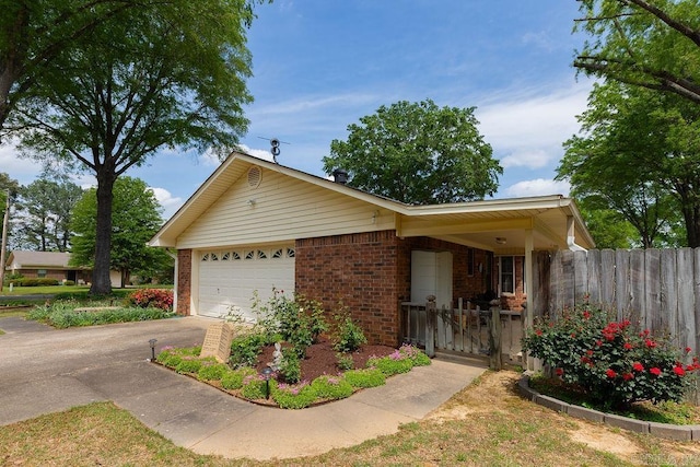 single story home with aphalt driveway, fence, brick siding, a gate, and an attached garage