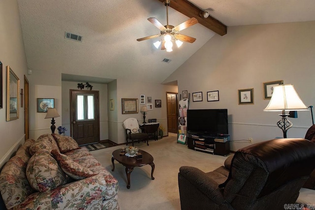 living room with visible vents, beamed ceiling, ceiling fan, high vaulted ceiling, and light colored carpet