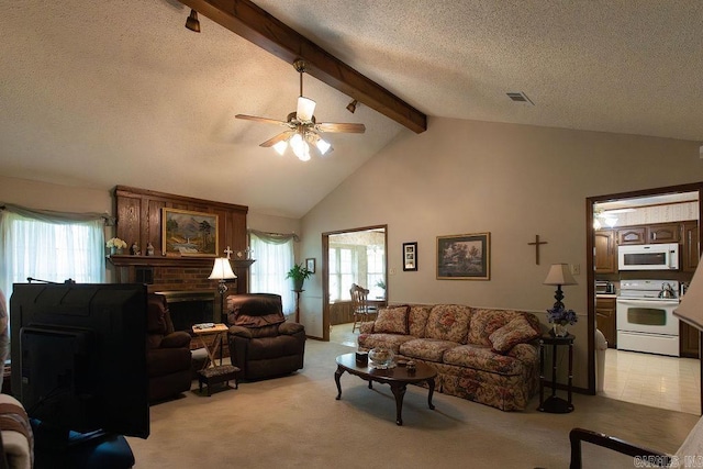 living area featuring a ceiling fan, a textured ceiling, light carpet, and beam ceiling