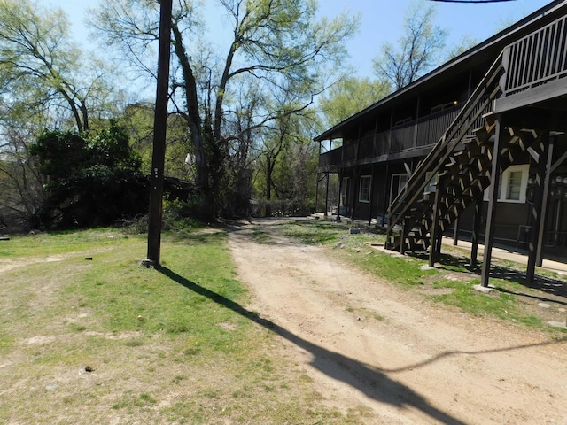 view of street featuring driveway and stairs