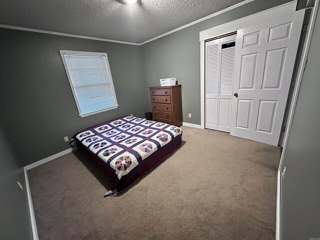 carpeted bedroom featuring crown molding, baseboards, a closet, and a textured ceiling
