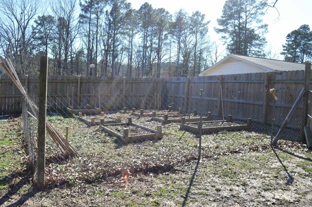 view of yard featuring a fenced backyard and a vegetable garden