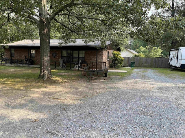 610 Reynolds Ave, White Hall, AR 71602 - rear view of house featuring fence, brick siding, and driveway