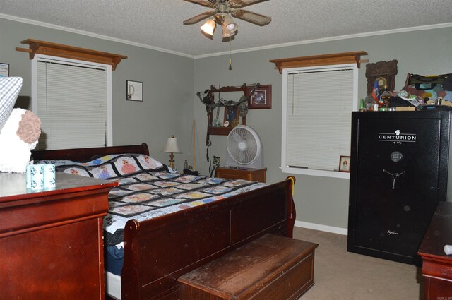 carpeted bedroom featuring ceiling fan, baseboards, ornamental molding, and a textured ceiling