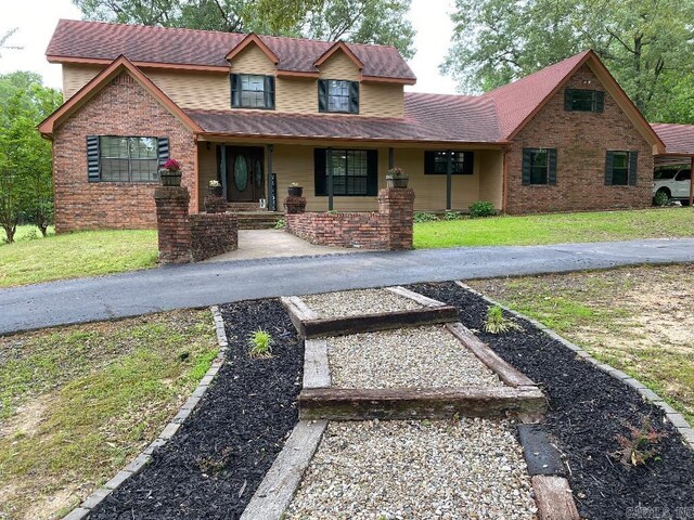 885 Mount Carmel Rd, Cabot, AR 72023 - view of front of home featuring a front yard, covered porch, and brick siding