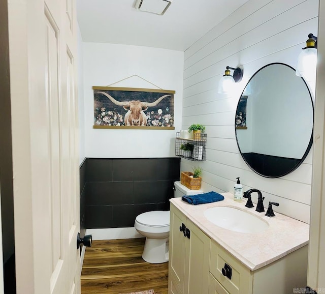 885 Mount Carmel Rd, Cabot, AR 72023 - half bathroom featuring wood finished floors, vanity, toilet, and wood walls