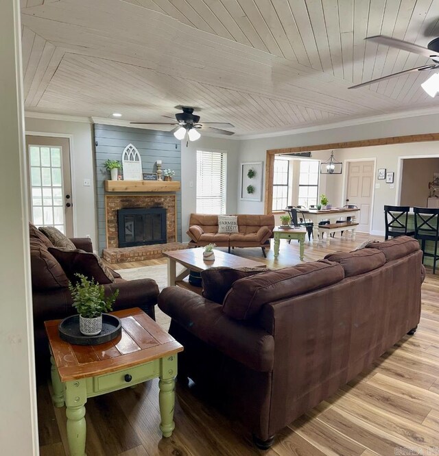 885 Mount Carmel Rd, Cabot, AR 72023 - living area with ceiling fan, ornamental molding, light wood-style floors, wood ceiling, and a fireplace