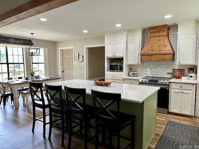 885 Mount Carmel Rd, Cabot, AR 72023 - kitchen with appliances with stainless steel finishes, custom exhaust hood, a kitchen island, white cabinets, and recessed lighting