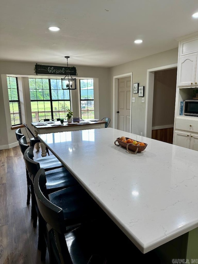 885 Mount Carmel Rd, Cabot, AR 72023 - kitchen with stainless steel microwave, white cabinetry, recessed lighting, dark wood finished floors, and baseboards