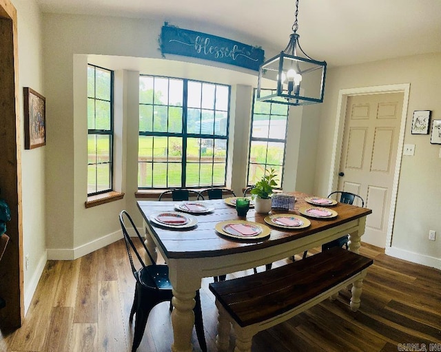 885 Mount Carmel Rd, Cabot, AR 72023 - dining area featuring baseboards, wood finished floors, and a chandelier