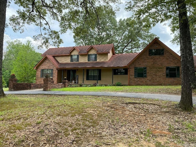 885 Mount Carmel Rd, Cabot, AR 72023 - view of front facade with a porch, a front lawn, and brick siding