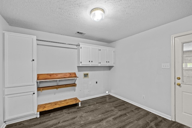 washroom featuring cabinet space, dark wood-style flooring, washer hookup, a textured ceiling, and electric dryer hookup