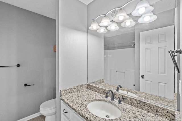 full bath with tile patterned flooring, vanity, toilet, baseboards, and a shower