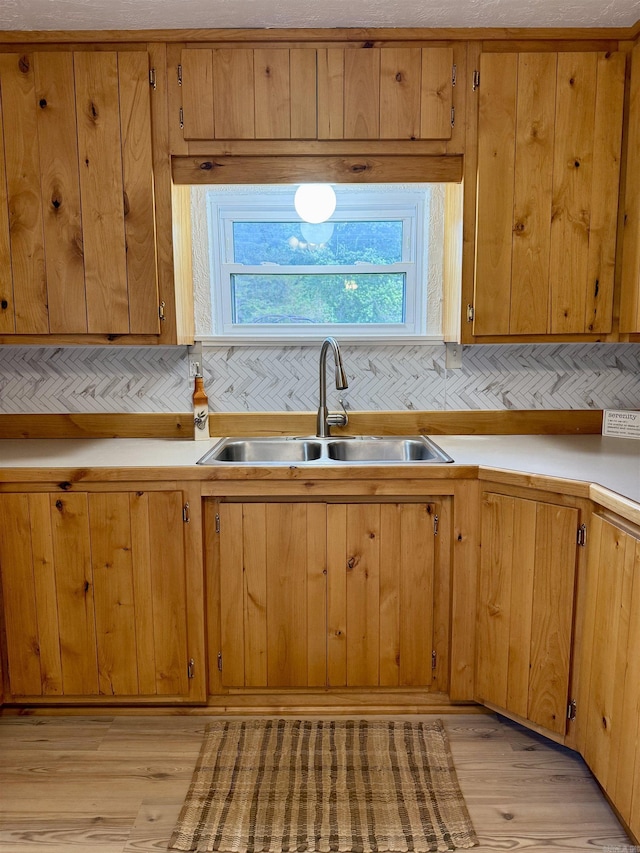 805 S St, Heber Springs, AR 72543 - kitchen featuring backsplash, a sink, and light wood-style flooring
