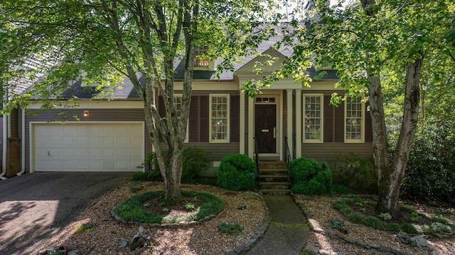 view of front of home featuring a garage and aphalt driveway