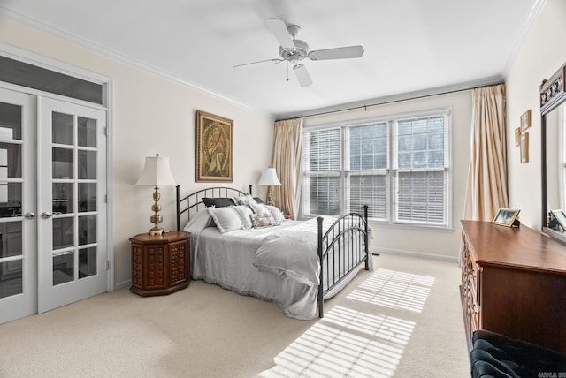 bedroom featuring crown molding, baseboards, ceiling fan, french doors, and carpet